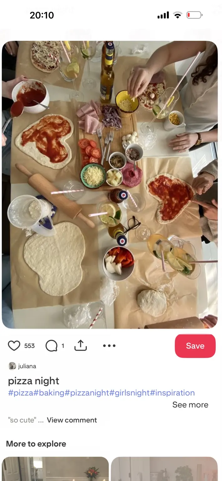 Friends adding toppings to homemade pizzas together